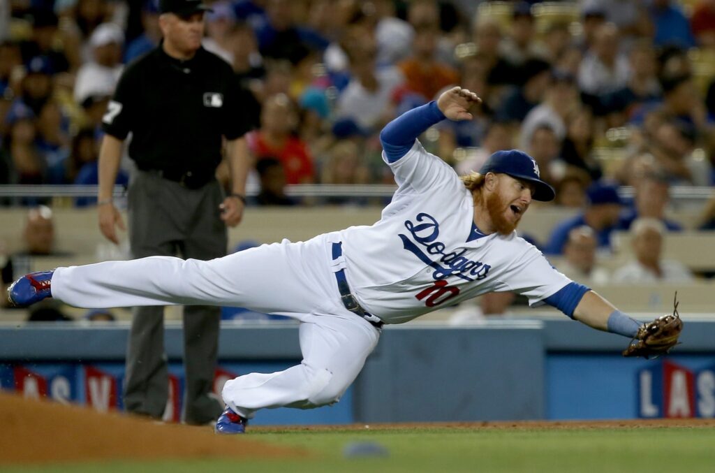 LOS ANGELES, CALIF. -  AUG. 21, 2014. Dodgers third baseman Justin Turner dives for a ball hit shraply off the bat of Padres left fielder Abraham Almonte in the seventh inning on Thursday, Aug. 21, 2014, at Dodger Stadium in Los Angeles.  (Luis Sinco/Los Angeles Times)